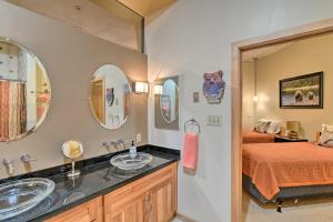 a bathroom with two sinks and a bed at Idyllic Dtwn Anchorage Condo with Fireplace! in Anchorage +19 photos