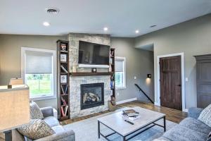 a living room with a fireplace and a tv at Chic Plymouth Townhome Less Than 1 Mi to Road America in Plymouth