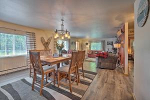 a dining room and living room with a table and chairs at Single-Story Soldotna Home Near the Kenai River! in Soldotna