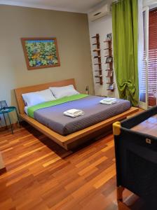 a bedroom with a large bed with green curtains at Ciampino Airport Apartment in Ciampino