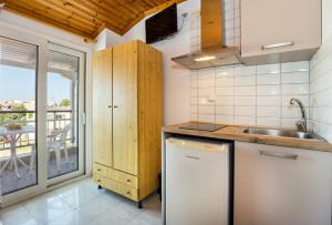 a kitchen with a sink and a counter at Kalogeraki Studios in Potos +59 photos