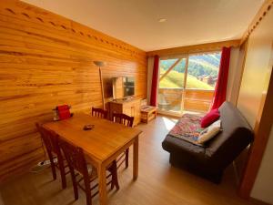 a living room with a table and a dining room at La Foux 2 pièces in Allos