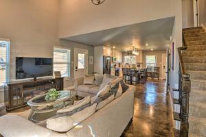 a living room with a couch and a table at Granbury Home with Hot Tub and Furnished Patio! in Granbury