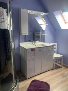 a bathroom with a sink and a mirror at Camping Les Pommiers in Sotteville-sur-Mer