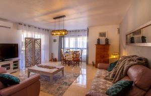 a living room with a couch and a table at Sun, Sea, Beach Costa Calida Spain Henrys Apartment in Águilas