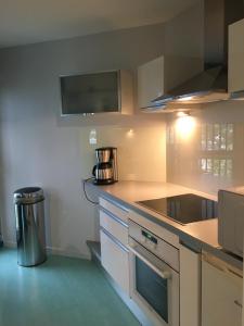 a kitchen with a counter and a trash can at A 50m de la mer in Agon Coutainville