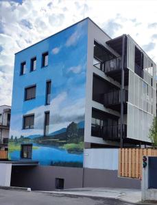 a building with a large mural on the side of it at Rest apartment Cerknica in Cerknica