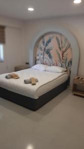 a large bed in a bedroom with a large headboard at Side Leon Otel in Side