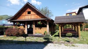 a house with a gazebo in a yard at Apartamenty nad Jeziorem in Międzybrodzie Żywieckie