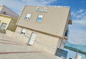 a building with the boma sign on the side of it at Apartments Bojana in Tivat