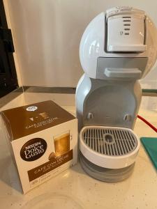 a coffee maker with a box next to it at Sun, Sea, Beach Costa Calida Spain Henrys Apartment in Águilas