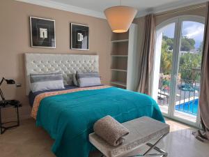 a bedroom with a bed and a large window at Villa Maracana in Marbella