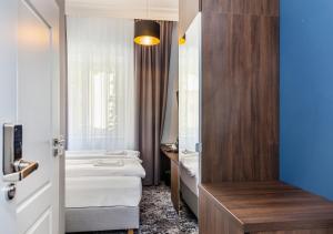 Posteľ alebo postele v izbe v ubytovaní Aparthotel Cracovia Residence