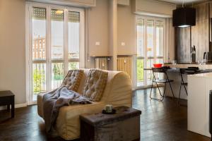 a living room with a couch and a table at La Preziosa Apartment - by Host4U in Pavia