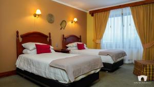 Postel nebo postele na pokoji v ubytování Malalcahuello Thermal Hotel & Spa + 37 fotografií