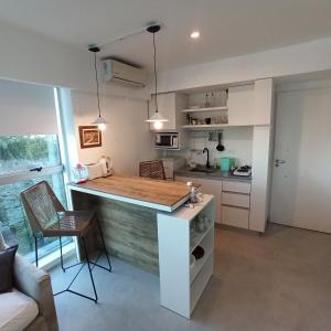 a kitchen with a island in the middle of a room at Ombu Loft Olivos, Vista al Rio in Olivos