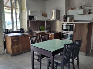 a kitchen with a table and chairs in it at Le Gite de la Loire in Rochecorbon +84 photos