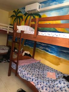 two bunk beds in a room with a mural at Vlora Backpackers Hostel & Bar in Vlorë