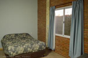 Säng eller sängar i ett rum på Cabañas Del Pago