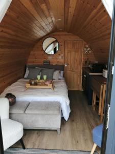 a bedroom in a log cabin with a bed and a chair at Luxury Glamping with lake & Mountain View in Culky