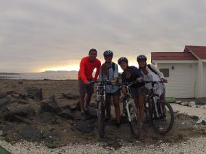 a group of people standing next to their bikes at Las Hualas in Punta de Choros
