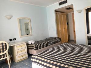 A bed or beds in a room at Baia dei Mulini Resort & Spa