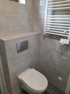 a bathroom with a white toilet and a sink at Przystań Mielnów in Mielnów +49 photos