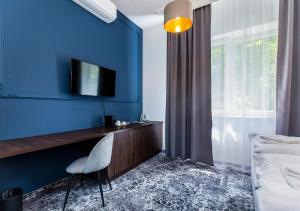 Televízia a/alebo spoločenská miestnosť v ubytovaní Aparthotel Cracovia Residence
