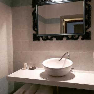 a white bowl sink on a counter in a bathroom at LA LOCANDA DELLA STAFFA in Pombia +25 photos