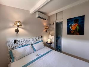 ein Schlafzimmer mit einem Bett und einem Wandgemälde in der Unterkunft Les Grimaldines - Maison d'Hôtes in Cagnes-sur-Mer