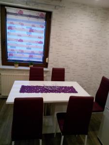 a conference room with a table and chairs with a large screen at Ferienwohnung Liselotte in Brotterode-Trusetal