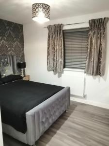 Schlafzimmer mit einem Bett und einem Fenster in der Unterkunft StayNEC LAMPREY- Lux Apartment - Birmingham - For Company, Contractor & Leisure Stays NEC, HS2, JLR, Airport in Kingshurst