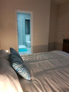 a bed with a pillow sitting on it in a bedroom at A Ground Floor Maisonette - Mellieha Bay in Is-Sellum
