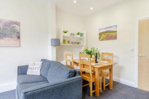 a living room with a table and a chair and a couch at Shuttle Apartment in Northallerton