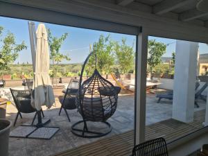 a screened in porch with a view of a patio at Ulivi di Minerva - Boutique Holiday Home - SUPER SUITE & SPA POLLON - Ostuni - Fasano - Cisternino in Montalbano