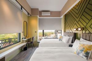 Postel nebo postele na pokoji v ubytování 森行旅 Mori Hotel -台南安平老街