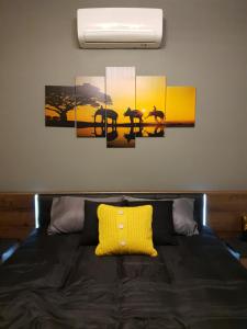 a bedroom with a bed with a yellow pillow on it at A Ground Floor Maisonette - Mellieha Bay in Is-Sellum