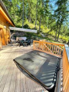 a mattress on a deck with a gazebo at Chalet de 5 chambres avec sauna jardin clos et wifi a Les Orres in Les Orres