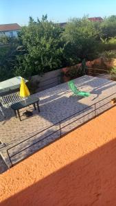 a playground with a picnic table and a green slide at Cassabella in Năvodari