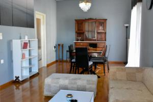 a living room with a table and a couch at Downtown Apartment Karystos in Karistos