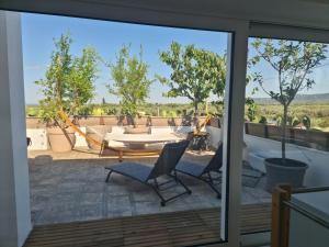 a view from the balcony of a house with a table and chairs at Ulivi di Minerva - Boutique Holiday Home - SUPER SUITE & SPA POLLON - Ostuni - Fasano - Cisternino in Montalbano