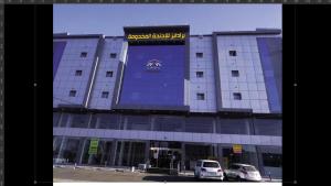 a large building with cars parked in front of it at برادايز للشقق المخدومة in Khamis Mushayt