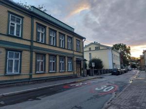 an empty street with a building and a road sign at Modern History Apartment in Tallinn