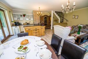 a kitchen and dining room with a table and chairs at Centrum Spokoju - Dom w Karkonoszach in Zachełmie