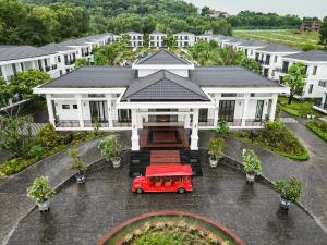 a house with a red car in front of it at DAD Resort Phú Quốc in Phú Quốc