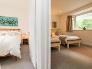 a bedroom with two beds and a window at Barleside in Dulverton