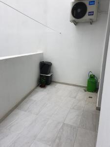a small room with a white wall and a floor at A Ground Floor Maisonette - Mellieha Bay in Is-Sellum