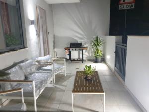 a living room with a couch and a table at A Ground Floor Maisonette - Mellieha Bay in Is-Sellum
