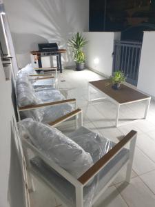 a room with three shelves with plastic on them at A Ground Floor Maisonette - Mellieha Bay in Is-Sellum