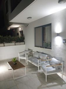 a living room with couches and a projection screen at A Ground Floor Maisonette - Mellieha Bay in Is-Sellum